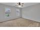 Bedroom with neutral carpeting, ceiling fan, and two windows offering natural light at 500 Pearl Place Ln, York, SC 29745
