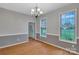 Spacious dining room with hardwood floors, featuring a chandelier and bright windows at 500 Pearl Place Ln, York, SC 29745