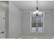 Dining room featuring a chandelier, a window view of the pool, and light gray walls at 500 Pearl Place Ln, York, SC 29745