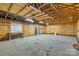 Unfinished spacious garage with wood walls, concrete floors, and an exit door at 500 Pearl Place Ln, York, SC 29745