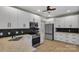 Well-lit kitchen featuring white cabinets, stainless steel appliances, and a black subway tile backsplash at 500 Pearl Place Ln, York, SC 29745