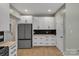 Bright kitchen with white cabinets, granite countertops, and stainless steel refrigerator at 500 Pearl Place Ln, York, SC 29745