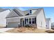 Charming single-Gathering home features a two-car garage and stone accents, set against a bright, sunny sky at 5096 Silver Creek Ln, Denver, NC 28037