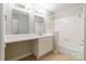Bright bathroom with shower-tub combo, updated vanity, and large countertop at 5832 Amity Springs Dr, Charlotte, NC 28212