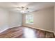 Spacious bedroom with ceiling fan, neutral paint, and large window allowing ample natural light at 5832 Amity Springs Dr, Charlotte, NC 28212