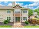 Charming tan home featuring two stories and a well-kept front yard landscape at 5832 Amity Springs Dr, Charlotte, NC 28212