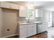 Bright kitchen with stainless steel dishwasher, double basin sink, and white cabinets at 5832 Amity Springs Dr, Charlotte, NC 28212