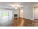 Open living room with hardwood floors, fireplace, and ceiling fan at 5832 Amity Springs Dr, Charlotte, NC 28212