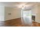 Spacious living room with a fireplace, ceiling fan and hardwood floors at 5832 Amity Springs Dr, Charlotte, NC 28212