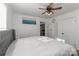 Spacious bedroom with gray headboard, ceiling fan, and ocean-themed art at 1002 Aiken St, Kannapolis, NC 28081