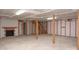 Unfinished basement featuring exposed beams, a fireplace, and ample storage space at 1207 S Poplar St, Landis, NC 28088