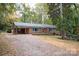 Brick ranch home with carport and red front door at 1207 S Poplar St, Landis, NC 28088