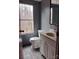 Small bathroom features a white toilet, single sink vanity, mirror, and a window for natural light at 1926 Scenic Dr, Iron Station, NC 28080