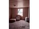 Small bedroom featuring neutral carpet, window, cardboard boxes, and a portable air conditioning unit at 1926 Scenic Dr, Iron Station, NC 28080