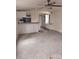 Open living room featuring a breakfast bar, neutral carpeting, neutral walls, and a hanging light fixture at 1926 Scenic Dr, Iron Station, NC 28080