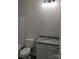 Well-lit bathroom featuring a granite countertop and a shower-tub combo at 1506 7Th St, Statesville, NC 28677