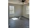 Bright bedroom featuring two windows offering natural light, modern ceiling fan and neutral paint scheme at 1506 7Th St, Statesville, NC 28677