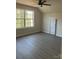 Spacious bedroom with ample natural light, ceiling fan, wood-look floors and a neutral color palette at 1506 7Th St, Statesville, NC 28677