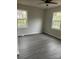 Spacious bedroom with new flooring and natural light pouring in through two windows at 1506 7Th St, Statesville, NC 28677