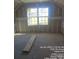 Unfinished bedroom with large window and visible framing at 1506 7Th St, Statesville, NC 28677
