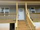 New construction home featuring a charming front porch with wood railings and gray siding at 1506 7Th St, Statesville, NC 28677