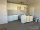 Spacious kitchen featuring white cabinets and modern lighting as construction is underway at 1506 7Th St, Statesville, NC 28677
