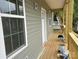 New construction home features a wooden porch with gray vinyl siding, multiple windows and ladder at 1506 7Th St, Statesville, NC 28677