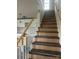 Interior view of a new home showing the stairway with wood and gray steps and white spindles at 1506 7Th St, Statesville, NC 28677