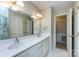 Bright bathroom featuring double sinks and a separate toilet room at 5444 Marengo Cir, Charlotte, NC 28216
