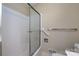 Modern bathroom featuring a shower with sliding glass door and accessibility handrail at 5444 Marengo Cir, Charlotte, NC 28216