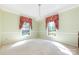 Open dining room featuring a chandelier and large windows with decorative valances at 5444 Marengo Cir, Charlotte, NC 28216