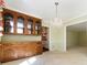 Light-filled dining room with a glass cabinet and doorway leading to the kitchen at 5444 Marengo Cir, Charlotte, NC 28216