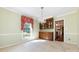 Dining room with a built-in china cabinet, chandelier, and view into another room at 5444 Marengo Cir, Charlotte, NC 28216