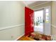 Bright foyer with a red front door, hardwood floors, and a view of the home's exterior at 5444 Marengo Cir, Charlotte, NC 28216