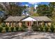 Inviting single-story brick home with a well-maintained lawn, mature trees, and a classic American flag at 5444 Marengo Cir, Charlotte, NC 28216