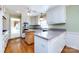 Bright kitchen featuring granite countertops, white cabinets, and a hardwood island at 5444 Marengo Cir, Charlotte, NC 28216