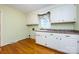Functional laundry room features white cabinetry, laminate countertops, and a window with decorative valance at 5444 Marengo Cir, Charlotte, NC 28216