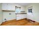 Practical laundry room includes cabinetry, sink, and an exterior door with a decorative curtain valance at 5444 Marengo Cir, Charlotte, NC 28216