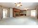 Spacious living room featuring a brick fireplace, carpet flooring, and access to multiple rooms at 5444 Marengo Cir, Charlotte, NC 28216