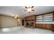 Cozy living room with a brick fireplace, carpet flooring, and built-in wooden cabinets and shelving for storage at 5444 Marengo Cir, Charlotte, NC 28216
