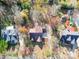 An aerial view shows a traditional home with a driveway surrounded by mature trees at 909 Woodhurst Dr, Monroe, NC 28110