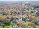 An aerial view of a residential neighborhood showing mature trees and manicured lawns at 909 Woodhurst Dr, Monroe, NC 28110