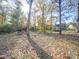Large backyard with mature trees offering ample space for outdoor activities and relaxation at 909 Woodhurst Dr, Monroe, NC 28110