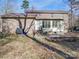 Well-maintained backyard featuring a brick patio area, lush lawn, and exterior brickwork at 909 Woodhurst Dr, Monroe, NC 28110