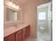 A bathroom with a tiled floor featuring a vanity with marble countertops and traditional fixtures at 909 Woodhurst Dr, Monroe, NC 28110