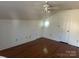 Cozy bedroom featuring hardwood floors, a unique window, and ample closet space at 909 Woodhurst Dr, Monroe, NC 28110