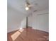 A bedroom with a ceiling fan and a closet featuring hardwood floors and natural light at 909 Woodhurst Dr, Monroe, NC 28110