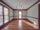 A dining room with hardwood flooring, a chandelier, and lots of natural lighting at 909 Woodhurst Dr, Monroe, NC 28110