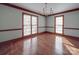 The dining room showcases hardwood floors, large windows and elegant chandelier at 909 Woodhurst Dr, Monroe, NC 28110