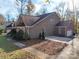 Two-story brick house featuring an attached two-car garage and large driveway at 909 Woodhurst Dr, Monroe, NC 28110